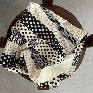Dettaglio di patchwork a pois e strisce su una borsa in tela stile minimalista