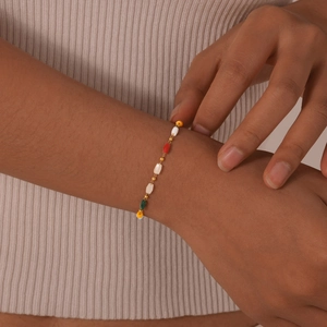 Close-up of colorful faceted beads and gold spacers on a vintage stainless steel bracelet