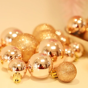 Assorted rose gold and champagne Christmas tree balls with glitter and matte finishes