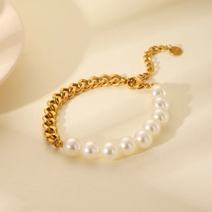 Close-up of 18K gold-plated Cuban chain spliced with lustrous white pearls on a bracelet