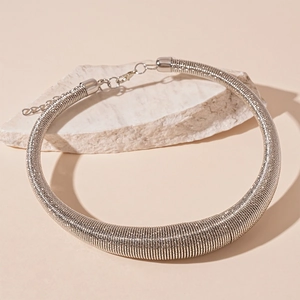 Detail of silver chunky metal choker featuring dense spiral texture and lobster clasp