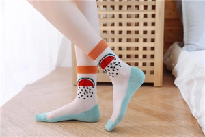 Detail of sheer glass silk socks featuring sweet watermelon print and green cotton accents
