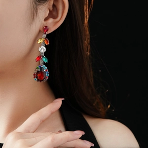 Detailed close-up of luxurious vintage drop earrings with colorful zircon crystals