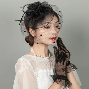 Vintage black mesh bridal headpiece with feathers and matching lace polka dot gloves