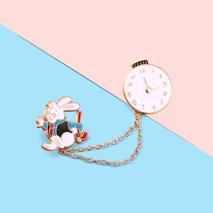 Detail of cartoon rabbit brooch with clock face and gold link chain accessory