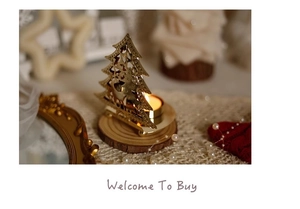 Macro shot of gold iron Christmas tree candle holder with reindeer cutout and wooden base