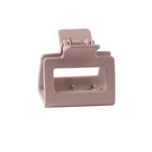 Detail view of square matte hair claw clip in dusty rose with internal comb structure