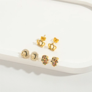 Three-pair set of gold Hamsa hand, crown, and oval stud earrings with colored zircons