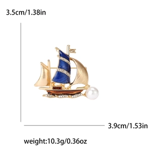 Elegant gold sailboat brooch with blue enamel sails, white pearl and sparkling crystals