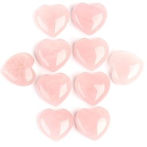 Set of 10 heart-shaped natural rose quartz stones with polished finish on white background