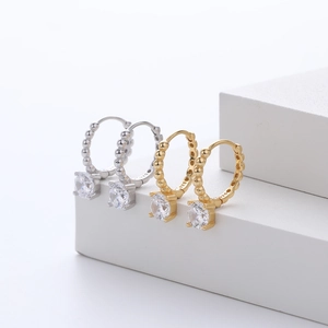 Macro view of S925 sterling silver hoop earrings with bead texture and cubic zirconia
