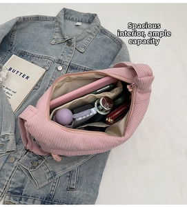 Interior view of large capacity pink corduroy bag with organized daily essentials