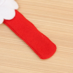 Detailed close-up of Christmas snap bracelet felt material with red and white stitching