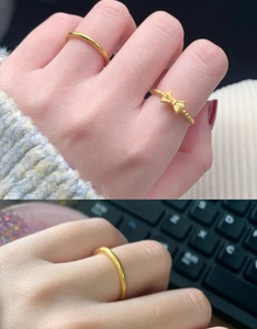 Close-up of 18K gold-plated bow ring and minimalist band on finger with elegant details