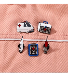 Set of 5 medical enamel pins including ambulance and syringe with rhinestone details