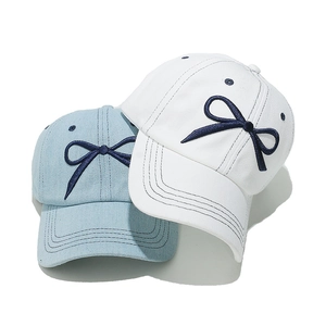Cute bow embroidered baseball caps in white and light blue denim with curved brims