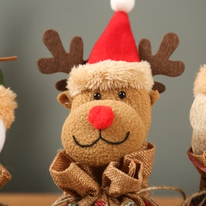 Detail of Christmas reindeer gift bag featuring red hat, felt antlers and linen textures
