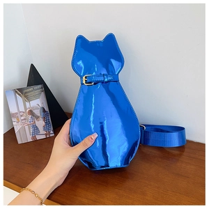 Close-up of bright blue cat-shaped crossbody bag with glossy patent leather finish