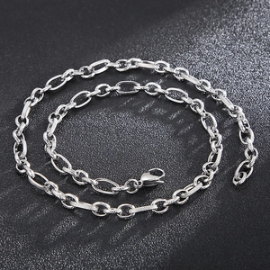 Macro shot of silver titanium steel O-chain necklace with textured oval links and clasp