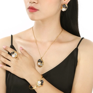 Luxury gold jewelry set featuring rose floral patterns, pearls and sparkling crystals