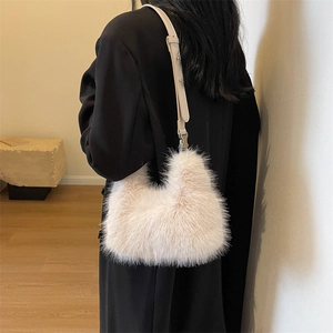 Plush faux fur shoulder bag in creamy beige with slender leather strap and metal buckles