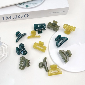 Detailed view of jelly-textured mini hair claws in various green and yellow geometric shapes