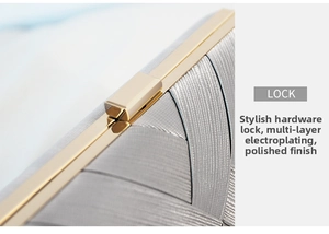 Detail of silver satin clutch with multi-layer electroplated gold metal clasp