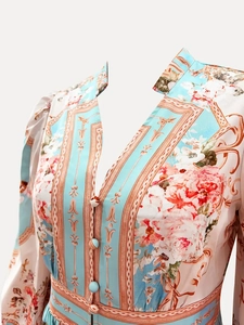 Macro shot of sky blue V-neck floral dress with vintage patterns and fabric buttons
