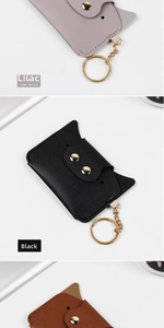 Detail of cat-shaped leather coin purses with litchi texture and gold keychains