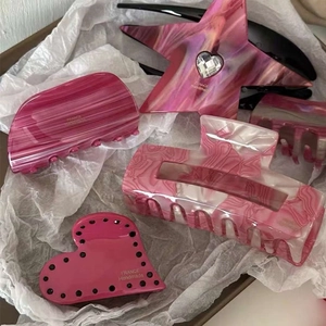 Pink acetate heart and star hair claw clips with rhinestones and marble patterns