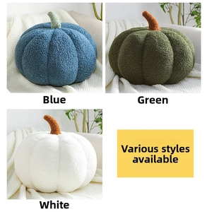 Detail of pumpkin pillows in blue green and white featuring plush teddy velvet texture