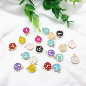 Assorted colorful enamel alphabet charms on silk fabric for DIY jewelry making