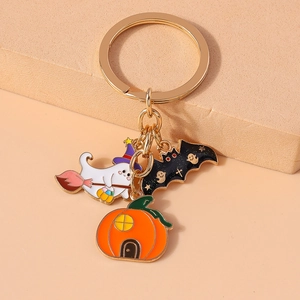 Detail of Halloween keychain with enamel ghost, black bat, and orange pumpkin house charms