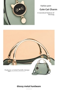 Detail of light green cat shell bag with golden ring handle and cute kitten charm