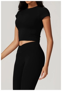 Detail of black yoga set featuring a slim-fit crop top and V-waist high-rise leggings