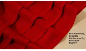 Macro view of solid red pashmina scarf showing detailed edge stitching and twill texture