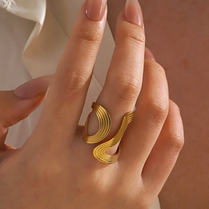 Minimalist irregular wave gold open ring with chunky geometric texture on hand
