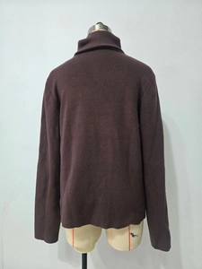 Rear view of brown knitted sweater on mannequin showing high collar and smooth texture