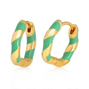 Detail of twisted gold metal hoop earrings with elegant green enamel finish on white background