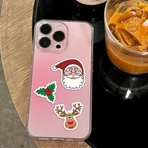 Detailed view of Christmas themed stickers on a pink iPhone case featuring Santa Claus