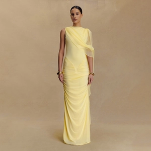 Detail of elegant yellow ruched slim fit maxi dress with sheer mesh shoulder drape