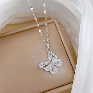 Detailed macro view of a silver butterfly pendant with sparkling cubic zirconia crystals