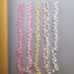 Detailed view of artificial cherry blossom vines in pink, yellow, and white colors