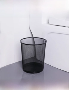 Close-up of black mesh metal wastebasket with durable round ventilated iron structure