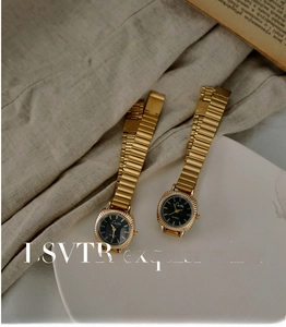 Close-up of vintage gold women's watch with black dial and detailed radial engraving