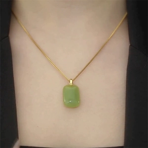 Light luxury gold necklace with green rectangular jade pendant shown on model