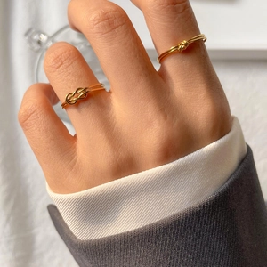 Minimalist knot gold rings for women featuring intertwined twist designs and polished finish