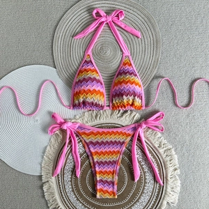 Detail of colorful chevron crochet bikini with side-tie bottoms on decorative mats