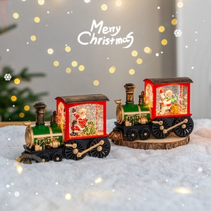 Christmas train snow globe music box with Santa snowman desktop decoration lights.