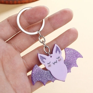 Detailed view of purple acrylic bat keychain with glitter wings and metal ring